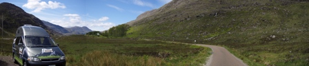 An OutThere campervan driving through Torridon