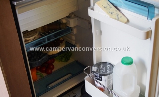 Campervan fridge with food for scale